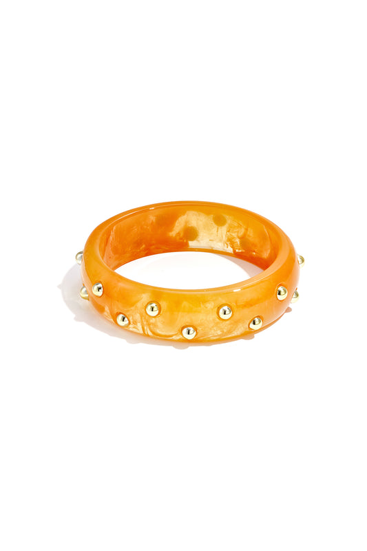 Oranje blush bangle met goudkleurige studs